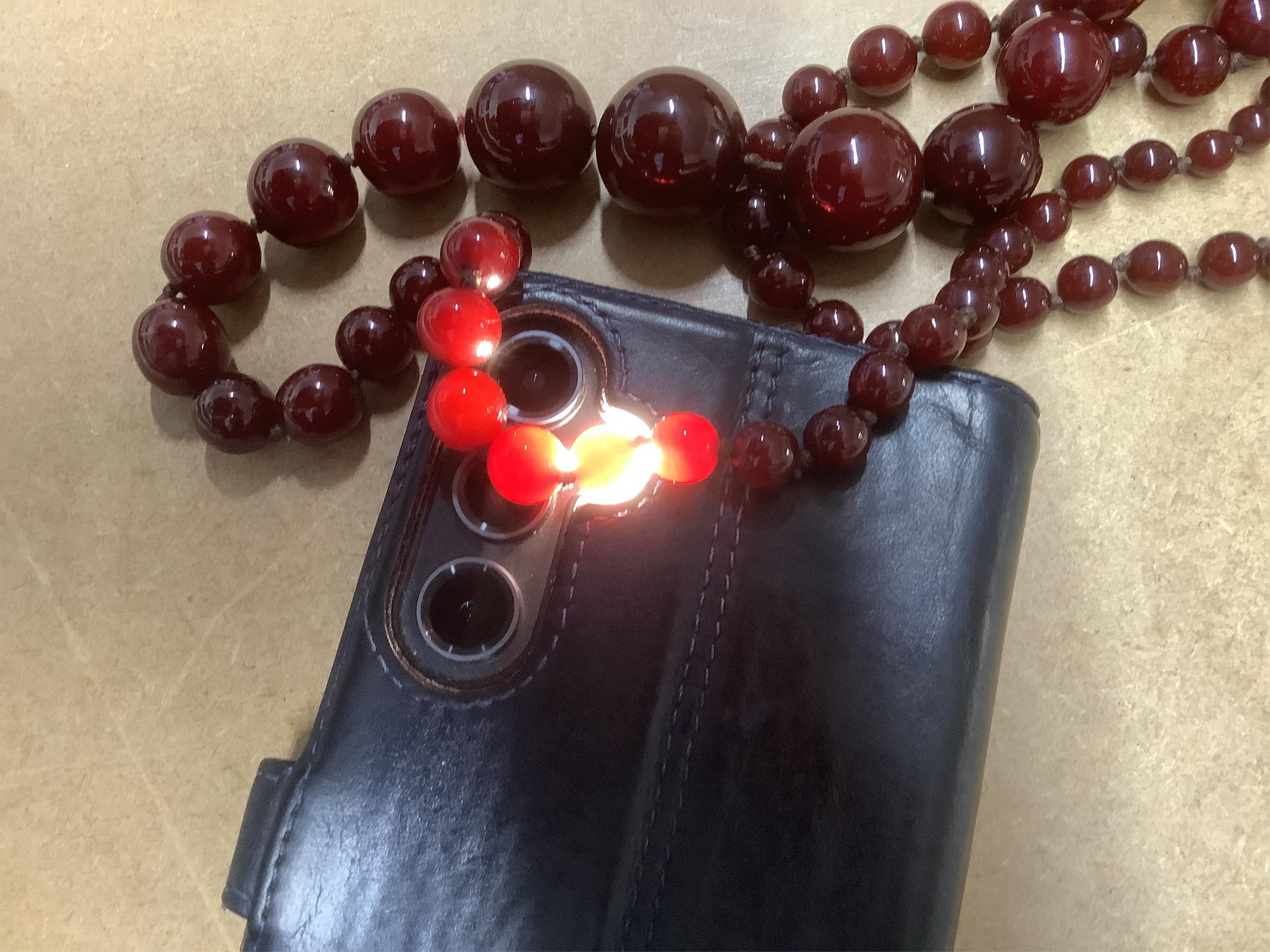 A cherry bakelite 'amber' necklace, composed of graduated spherical beads measuring approximately 6.7-23mm diameter, length approximately 86cm, gross weight 72 grams.